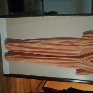 A beautiful peach jumpsuit the shirt snaps in sid